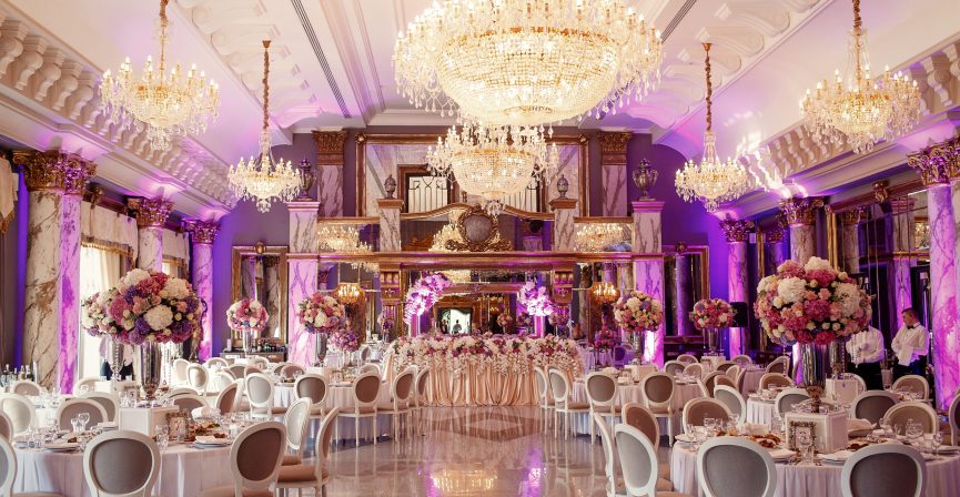 Luxurious dinner hall with large crystal chandeliers hanging from the ceiling