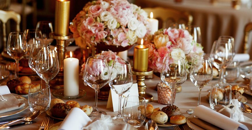 Rich dinner table served in pink and golden tones